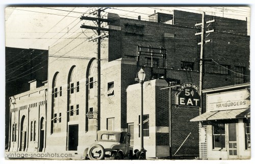 Vintage photo of a city street with diner, dated 1937