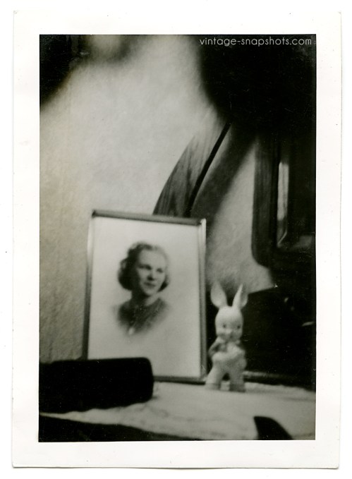portrait-rabbit Odd, dreamy abstract photo of a framed portrait next to a bunny figure sitting on a table