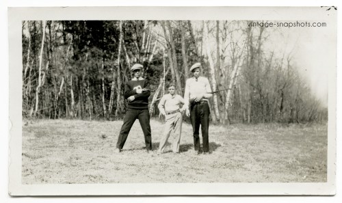 Odd vintage snapshot of two brothers flanking a small guy with a pistol pointed at him. Circa 1920s