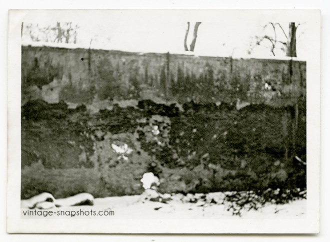Vintage snapshot photo of a wall against which German soldiers in WWII executed prisoners