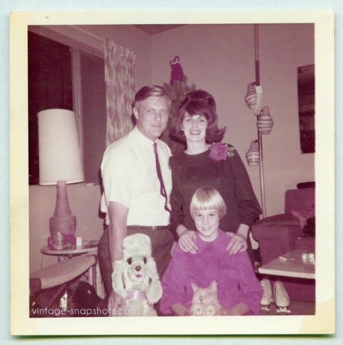 quirky odd 1960s vintage Christmas family poses with toy dog and closed-eyes cat